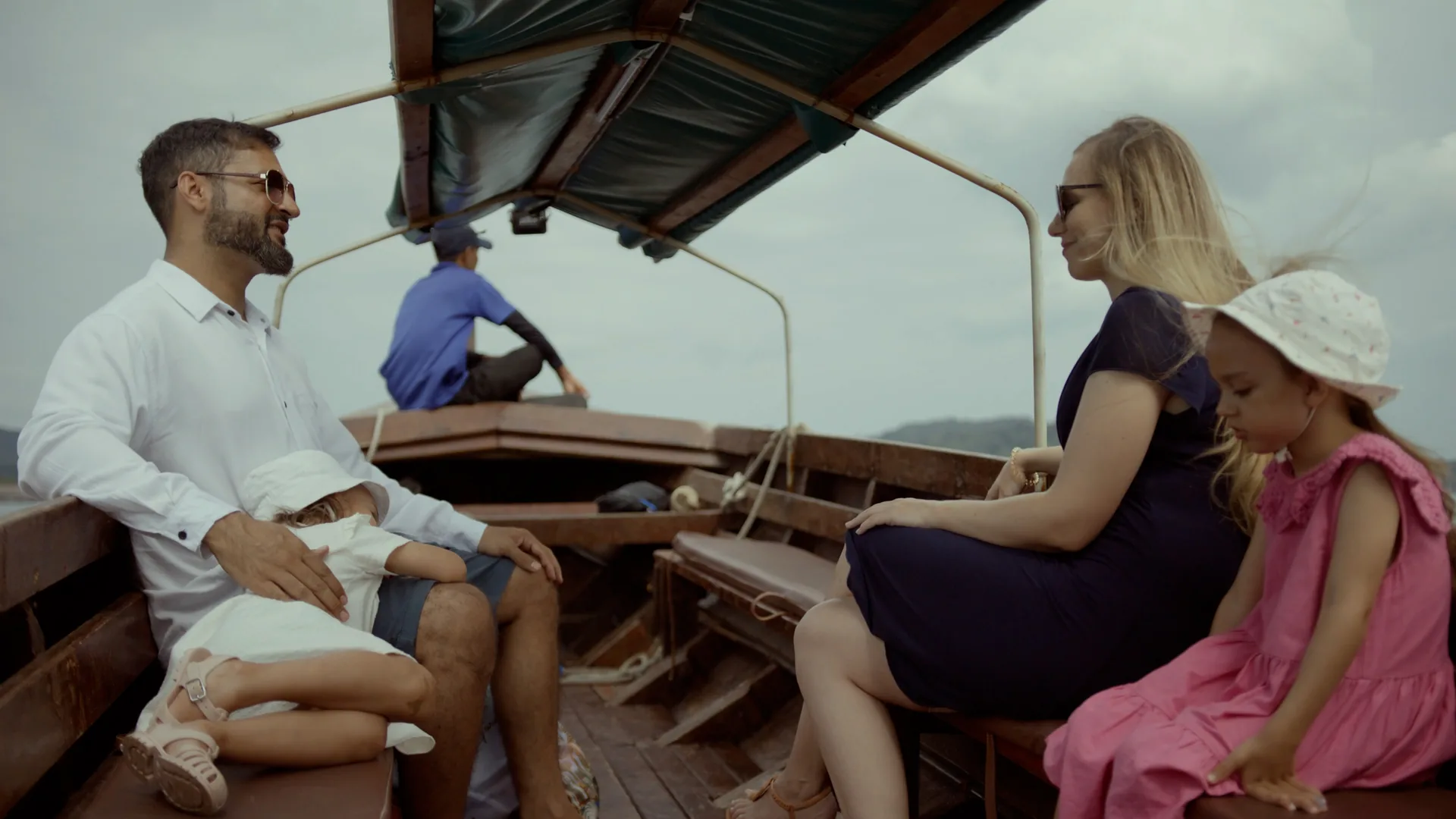 A family seated with crew on the covered local ferry used for the Telunas transfer from Sekupang.