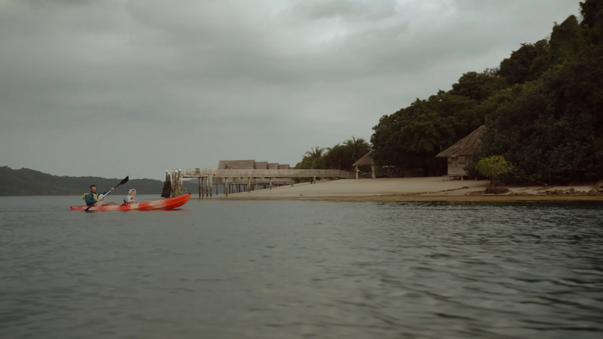 Father and daughter kayaking at Telunas Private Island during a family holiday