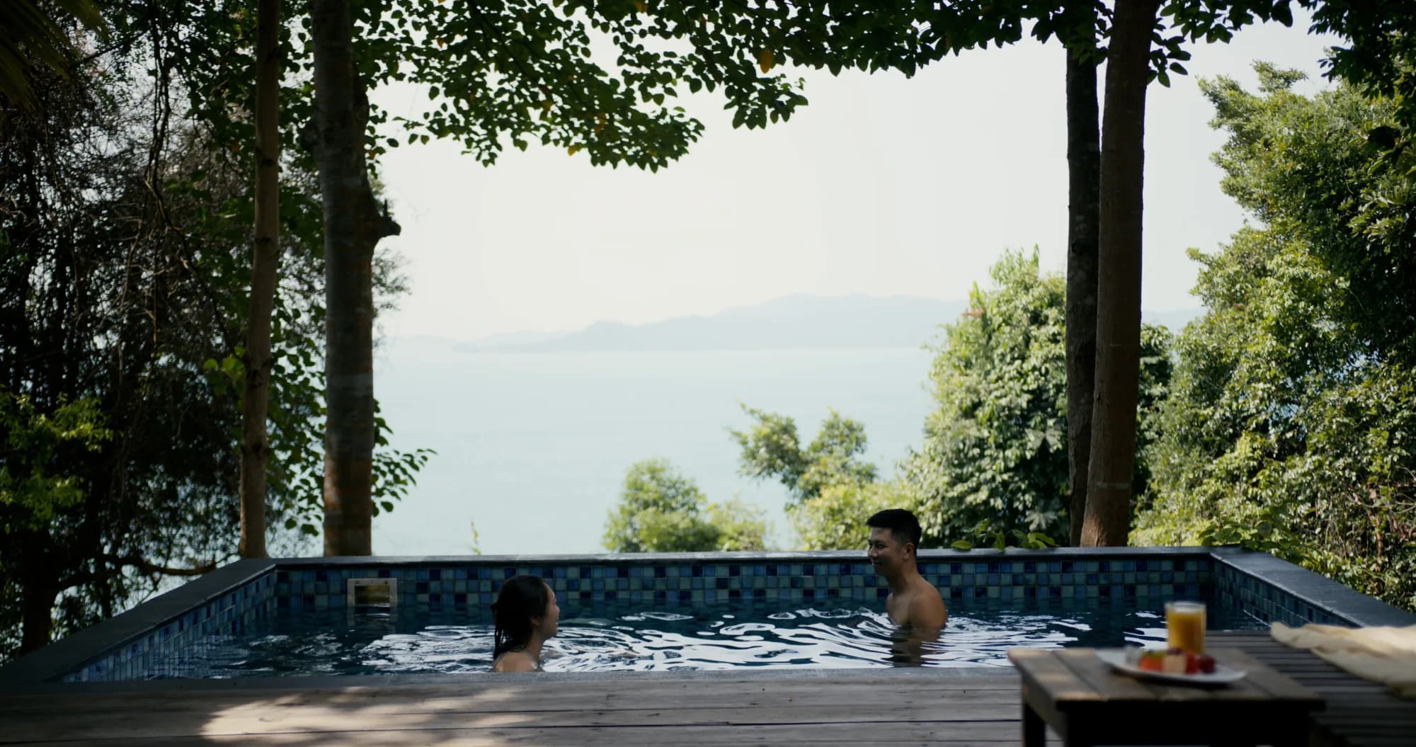 Couple relaxing in a Ridge Villa plunge pool at Telunas Private Island