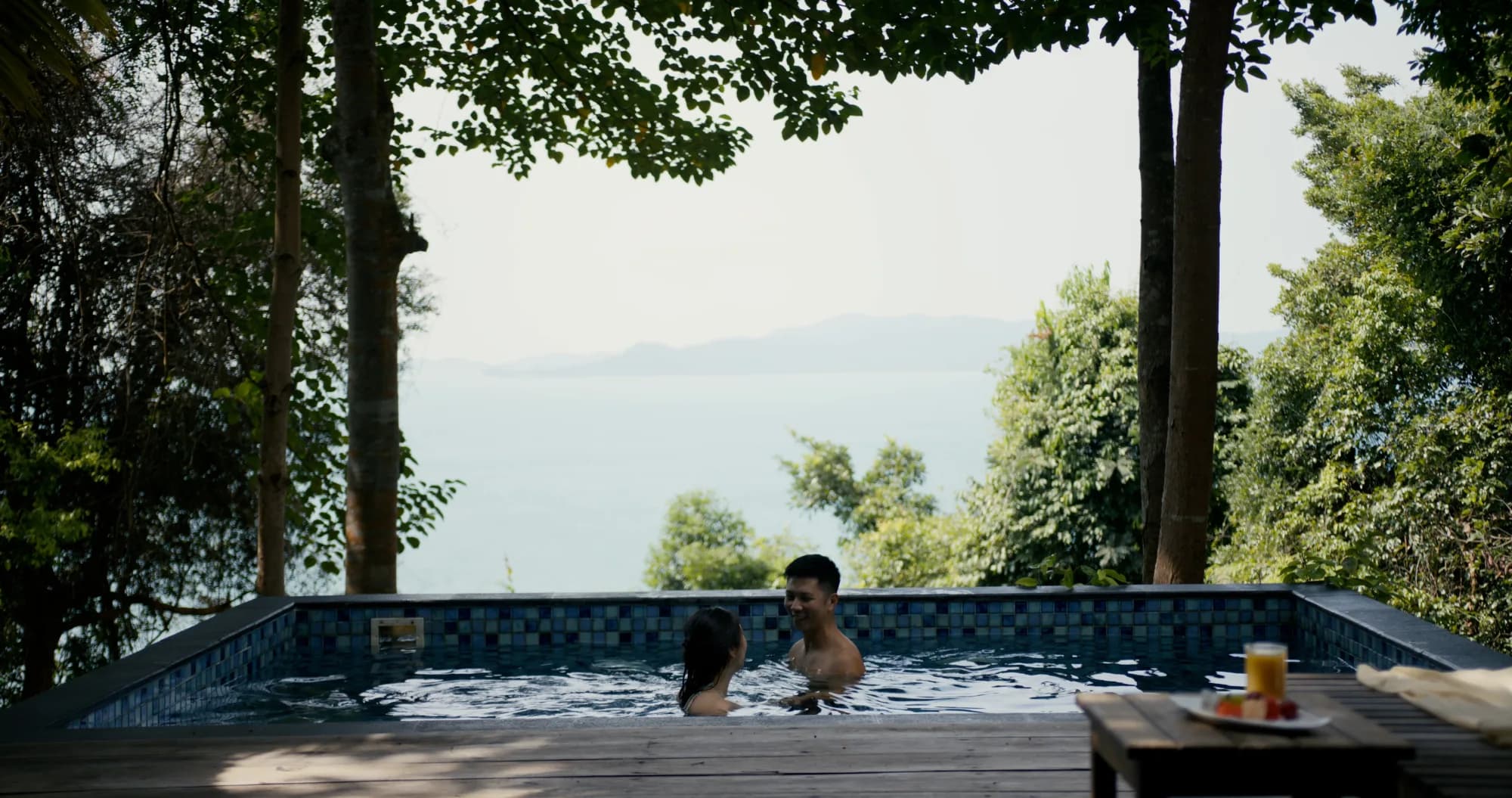 Couple in the private plunge pool at a Ridge Villa, Telunas Private Island