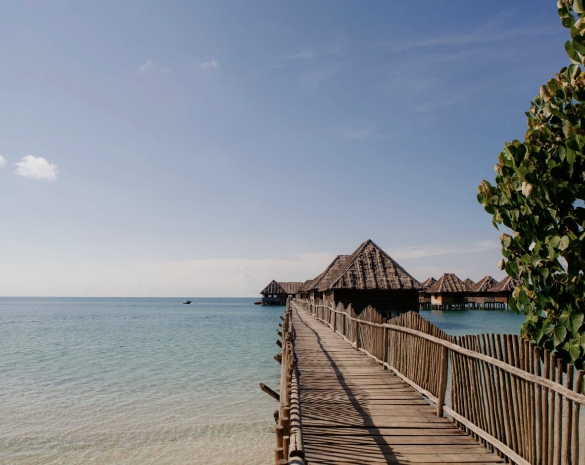 a wooden walkway leading to a beach